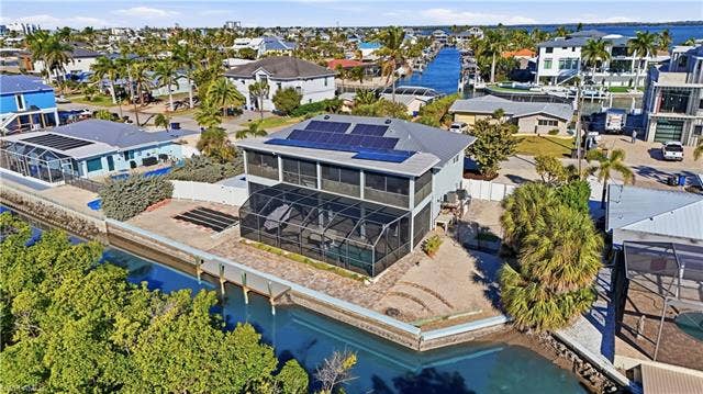 48 Fairview Blvd, Fort Myers Beach, FL 33931 Aerial perspective of suburban area with a nearby body of water - Virtually Edited Image