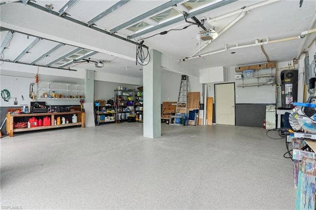 48 Fairview Blvd, Fort Myers Beach, FL 33931 Garage featuring a garage door opener - Virtually Edited Image