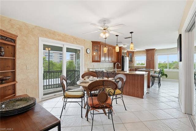 48 Fairview Blvd, Fort Myers Beach, FL 33931 Dining room with ceiling fan and light tile patterned floors - Virtually Edited Image