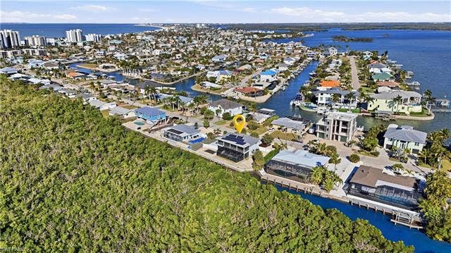 48 Fairview Blvd, Fort Myers Beach, FL 33931 Aerial overview of property's location featuring nearby suburban area and a nearby body of water - Virtually Edited Image