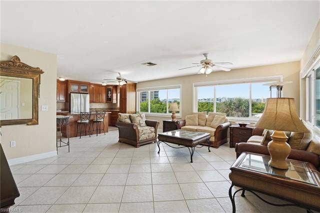 48 Fairview Blvd, Fort Myers Beach, FL 33931 Living area featuring a ceiling fan and light tile patterned flooring - Virtually Edited Image