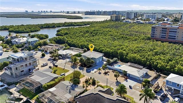 48 Fairview Blvd, Fort Myers Beach, FL 33931 Aerial view of property's location featuring city skyline and a nearby body of water - Virtually Edited Image