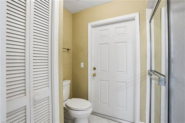 48 Fairview Blvd, Fort Myers Beach, FL 33931 Bathroom with a closet and tile patterned flooring - Virtually Edited Image