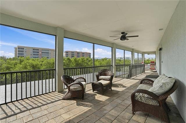 48 Fairview Blvd, Fort Myers Beach, FL 33931 Sunroom with ceiling fan and outdoor lounge area