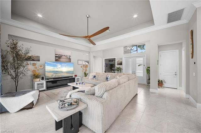 9796 Strike Ln, Bonita Springs, FL 34135 Recessed lighting, tray ceiling, tile flooring, crown molding, and a paneled entry door