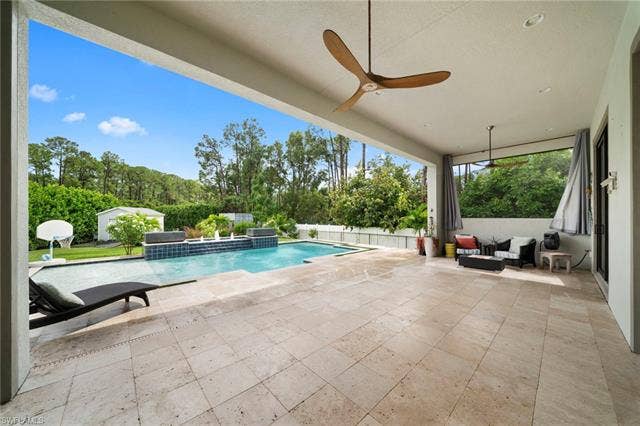 9796 Strike Ln, Bonita Springs, FL 34135 Expansive covered patio with large format tile flooring and dual ceiling fans