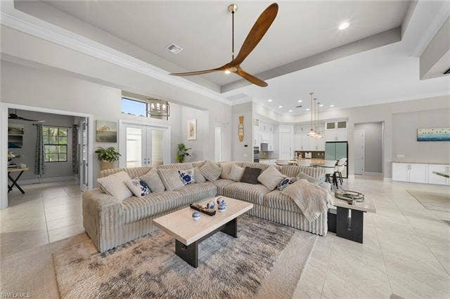 9796 Strike Ln, Bonita Springs, FL 34135 Recessed lighting, tray ceiling, tile flooring, glass-paneled double doors, and pendant lighting