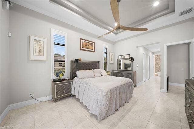 9796 Strike Ln, Bonita Springs, FL 34135 Tray ceiling with recessed lighting, ceiling fan, tile flooring, and tall transom windows