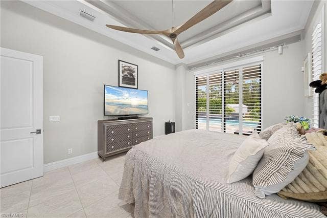 9796 Strike Ln, Bonita Springs, FL 34135 Tray ceiling with a modern ceiling fan, tile flooring, and white interior door