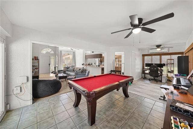 3730 21st Pl, Cape Coral, FL 33914 Spacious room featuring tile flooring, a ceiling fan with integrated lighting, and multiple windows