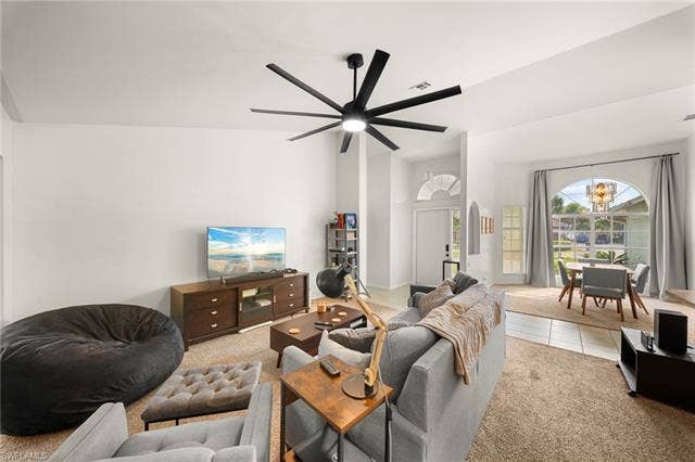 3730 21st Pl, Cape Coral, FL 33914 Vaulted ceilings, a contemporary ceiling fan, and light-colored walls define this open living area
