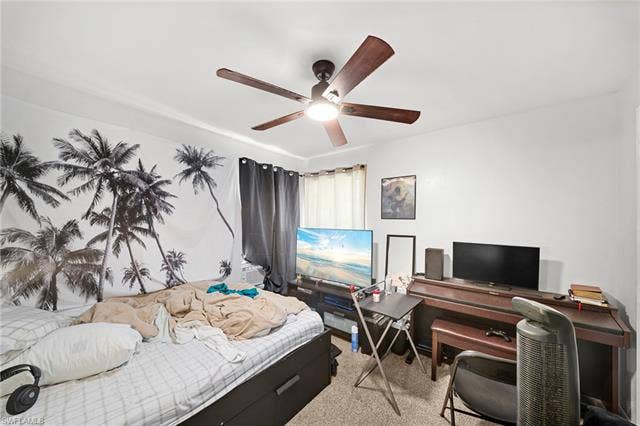 3730 21st Pl, Cape Coral, FL 33914 Carpeted room with a ceiling fan, window with curtain panels, and a wood-finish piano