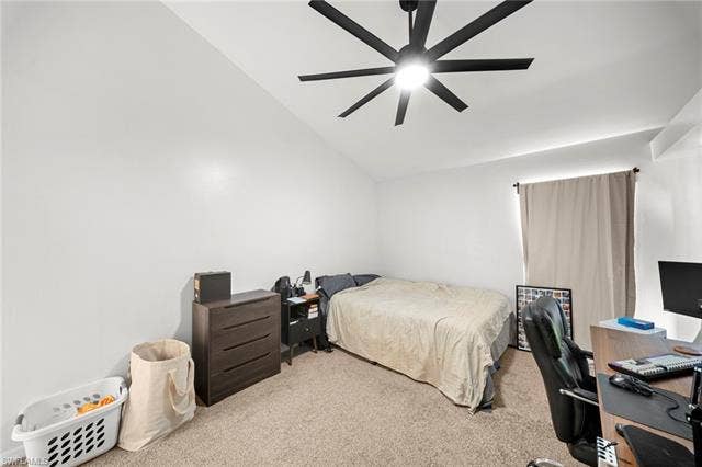 3730 21st Pl, Cape Coral, FL 33914 Vaulted ceiling with a contemporary ceiling fan, carpeted flooring, and a window with curtain rod