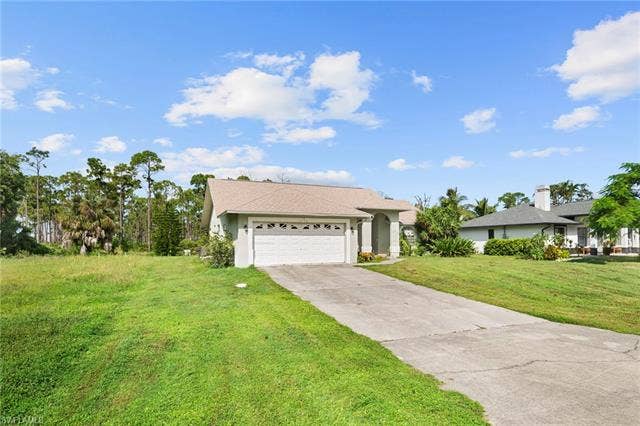 3730 21st Pl, Cape Coral, FL 33914 Single-story residence with an attached garage, a concrete driveway, and a light-colored shingle roof