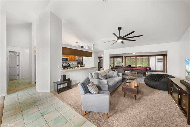 3730 21st Pl, Cape Coral, FL 33914 Vaulted ceilings, a black ceiling fan, and a kitchen with wood cabinetry