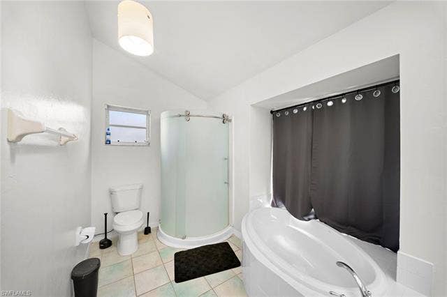 3730 21st Pl, Cape Coral, FL 33914 Recessed bathtub with deck-mounted faucet, separate shower enclosure with frosted glass door, and a single-pane window
