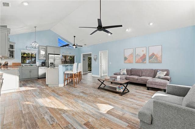 323 Washington Ct, Fort Myers Beach, FL 33931 INVITING LIVING SPACE FEATURING NEW FLOORING AND ROOM TO UNWIND.