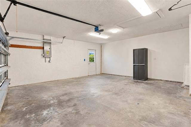 323 Washington Ct, Fort Myers Beach, FL 33931 OVERSIZED TWO-PLUS CAR GARAGE WITH GENEROUS SPACE FOR VEHICLES AND STORAGE.