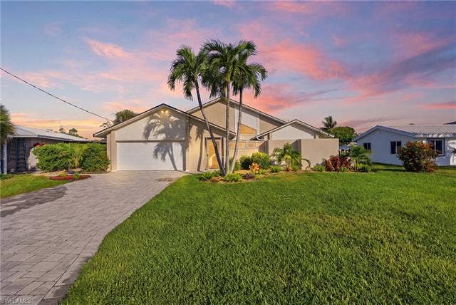 323 Washington Ct, Fort Myers Beach, FL 33931 FRESH CURB APPEAL WITH A NEW PAVER DRIVEWAY, LANDSCAPING AND ROOF.