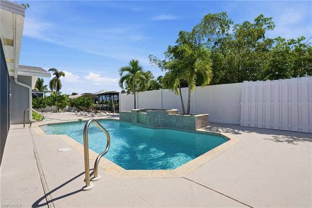 310 Madison Ct, Fort Myers Beach, FL 33931 Sparkling pool with large pool deck
