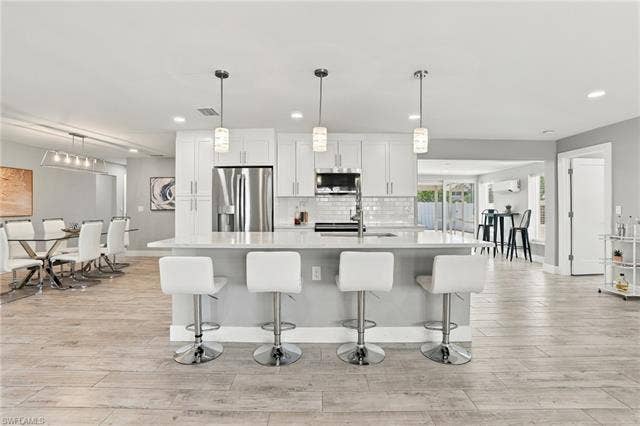 310 Madison Ct, Fort Myers Beach, FL 33931 Beautifully renovated kitchen with island and bar stools