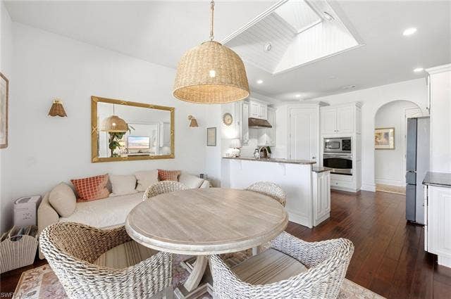 1936 Empress Ct, Naples, FL 34110 Recessed lighting, wood-finish flooring, white cabinetry, kitchen island with countertop, and skylight