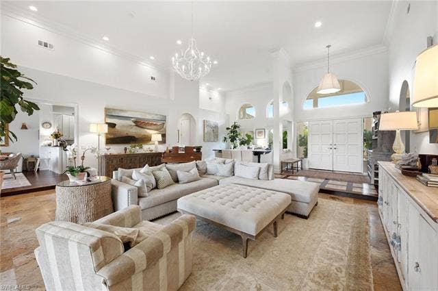 1936 Empress Ct, Naples, FL 34110 Vaulted ceilings, arched windows, grand double entry doors, recessed lighting, and tile flooring