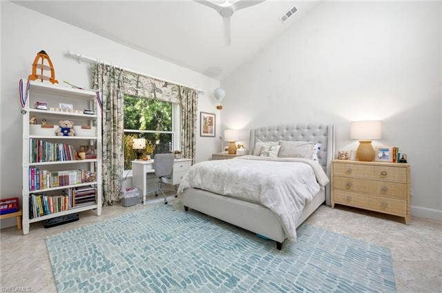 1936 Empress Ct, Naples, FL 34110 Vaulted ceiling with a ceiling fan, large window with drapes, and a secret treehouse in closet