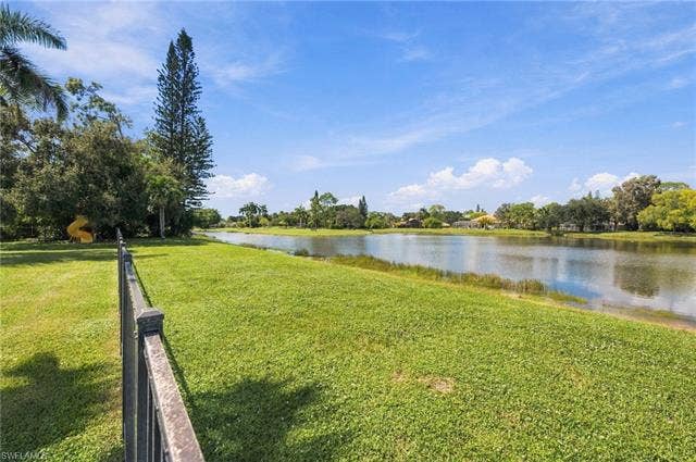 1936 Empress Ct, Naples, FL 34110 Expansive almost 1 Acre lot with green space featuring a lake view