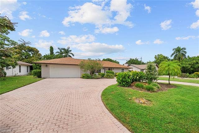 2171 Kings Lake Blvd, Naples, FL 34112 Paved driveway leading to a two-car garage