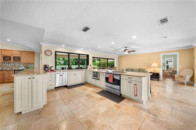 2171 Kings Lake Blvd, Naples, FL 34112 Spacious kitchen featuring an island, light-toned cabinetry, stainless steel appliances, recessed lighting, and tile flooring