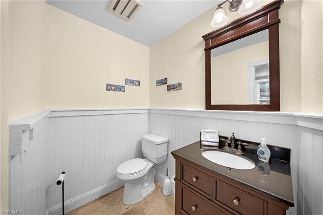 2171 Kings Lake Blvd, Naples, FL 34112 Dark wood vanity with an integrated sink and dark countertop