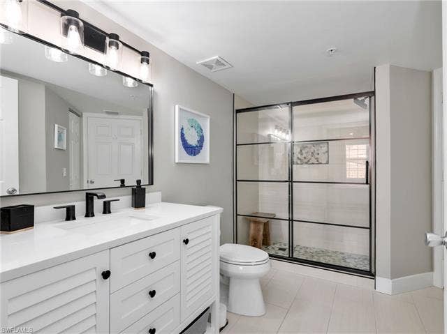 8659 River Homes Ln, #1202, Bonita Springs, FL 34135 Beautifully updated guest bath with crisp white cabinetry, modern finishes, and a bright, fresh design your guests will appreciate