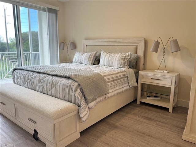 26600 Rosewood Pointe Dr, #B-107, Bonita Springs, FL 34135 Bedroom featuring access to exterior and hardwood / wood-style floors