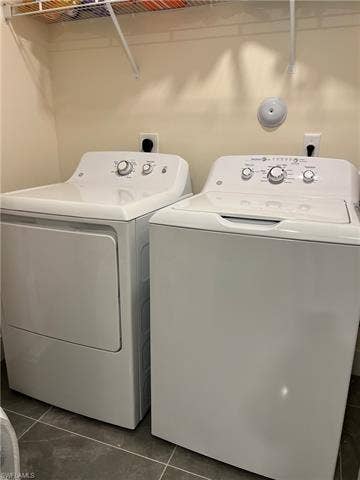 26600 Rosewood Pointe Dr, #B-107, Bonita Springs, FL 34135 Washroom with separate washer and dryer and dark tile patterned flooring