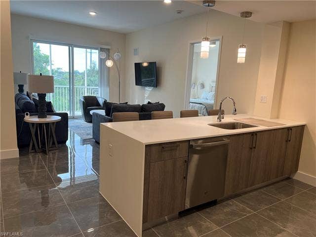 26600 Rosewood Pointe Dr, #B-107, Bonita Springs, FL 34135 Kitchen featuring pendant lighting, stainless steel dishwasher, and sink
