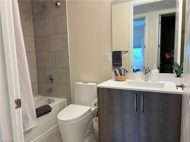 26600 Rosewood Pointe Dr, #B-107, Bonita Springs, FL 34135 Full bathroom with tile patterned floors, shower / tub combo with curtain, vanity, and toilet