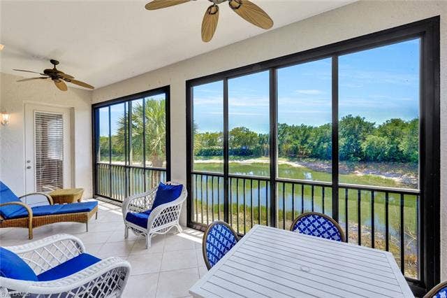 10060 Valiant Ct, #202, Miromar Lakes, FL 33913 Screened patio featuring a water and natural landscape backdrop