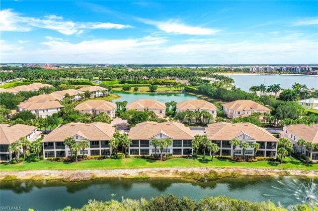 10060 Valiant Ct, #202, Miromar Lakes, FL 33913 Residential community featuring multiple buildings with private balconies and screened enclosures