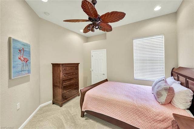 10060 Valiant Ct, #202, Miromar Lakes, FL 33913 Bedroom featuring neutral wall paint, recessed lighting, carpet flooring, a ceiling fan with leaf-shaped blades, and a window with horizontal blinds