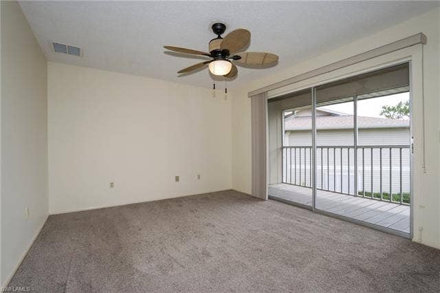 25484 Cockleshell Dr, #901, Bonita Springs, FL 34135 Carpeted empty room featuring ceiling fan and plenty of natural light