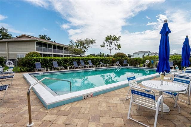 25484 Cockleshell Dr, #901, Bonita Springs, FL 34135 Community pool featuring a patio