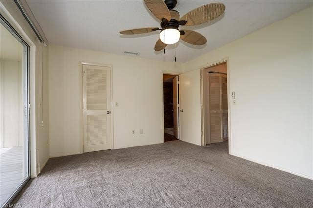 25484 Cockleshell Dr, #901, Bonita Springs, FL 34135 Unfurnished bedroom with carpet floors, ceiling fan, and access to outside