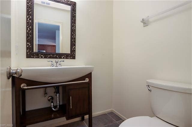 25484 Cockleshell Dr, #901, Bonita Springs, FL 34135 Half bath with tile patterned floors and vanity