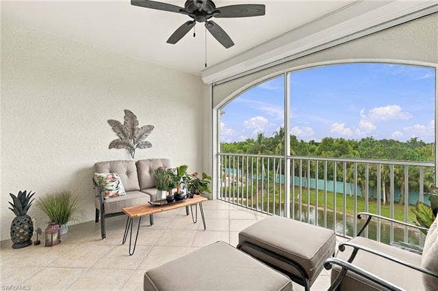 11041 Gulf Reflections Dr, #403, Fort Myers, FL 33908 Screened balcony with tiled flooring, arched window framing, and a ceiling fan