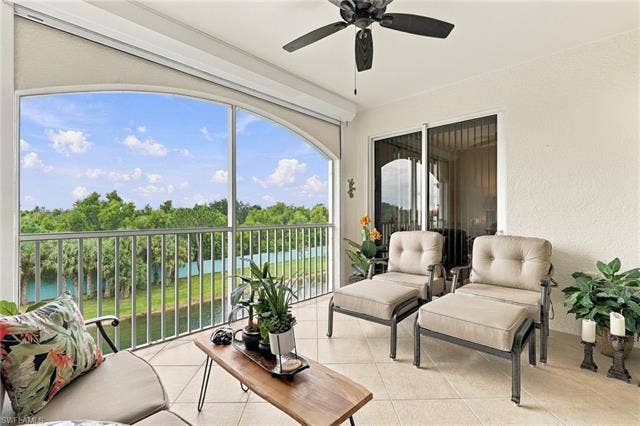 11041 Gulf Reflections Dr, #403, Fort Myers, FL 33908 Screened balcony featuring a tiled floor, ceiling fan, and sliding glass doors
