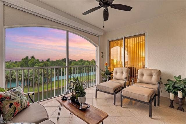11041 Gulf Reflections Dr, #403, Fort Myers, FL 33908 Screened lanai featuring a ceiling fan, tiled flooring, and a water feature