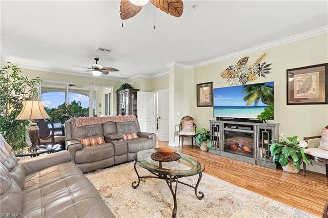 11041 Gulf Reflections Dr, #403, Fort Myers, FL 33908 Living area featuring crown molding, recessed lighting, wood-finish flooring, a ceiling fan, and sliding glass doors to the exterior