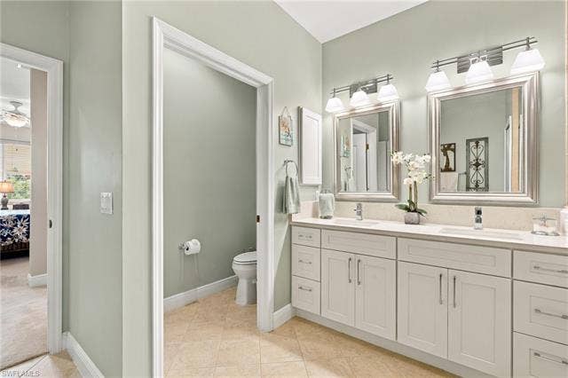 11041 Gulf Reflections Dr, #403, Fort Myers, FL 33908 Dual vanity with undermount sinks, quartz countertop, and white shaker-style cabinetry