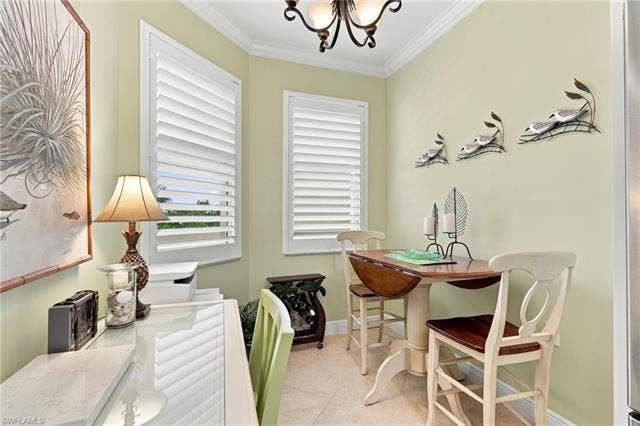 11041 Gulf Reflections Dr, #403, Fort Myers, FL 33908 Plantation shutters, crown molding, wall-mounted light fixture, and tile flooring